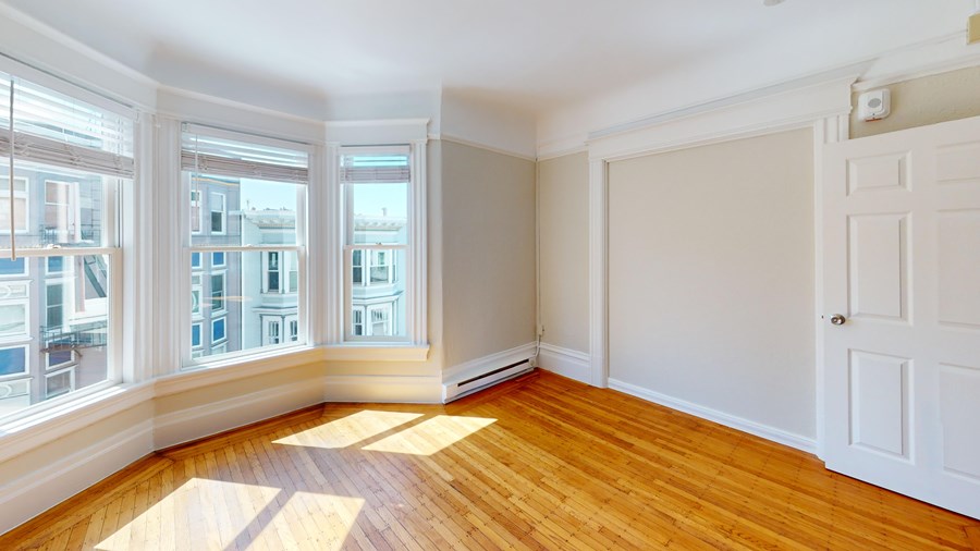 A room with wooden floors and white walls.